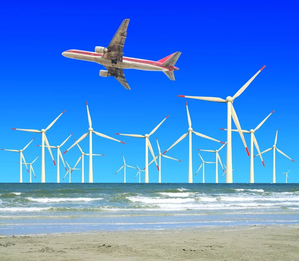 Aircraft is flying in eco power of wind turbines — Stock Photo, Image