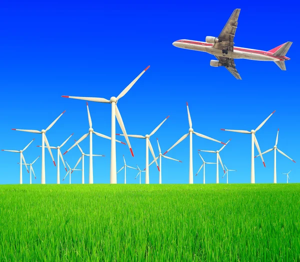 Aircraft is flying in the rice farms Modern wind turbines — Stock Photo, Image