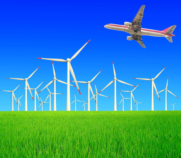 Aircraft is flying in the rice farms Modern wind turbines