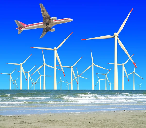 Aircraft is flying in eco power of wind turbines — Stock Photo, Image