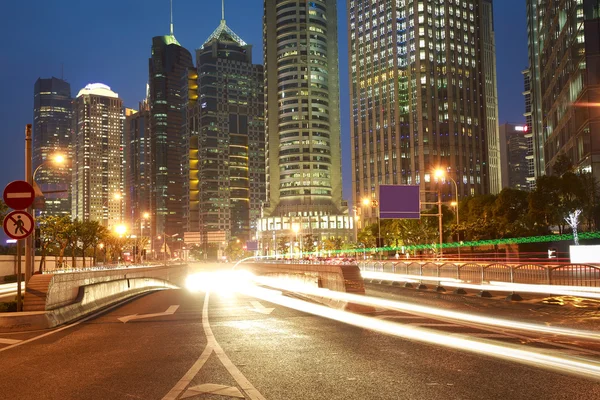 The light trails on the modern building background in shanghai — Stock Photo, Image