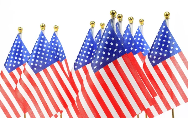 Us flags hanging on the gold flagpole — Stock Photo, Image