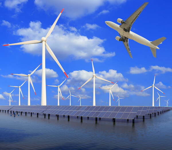 Aircraft is flying in eco power of wind turbines and solar panel