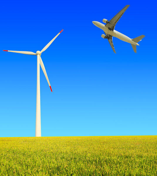 Aircraft is flying in the rice farms Modern wind turbines