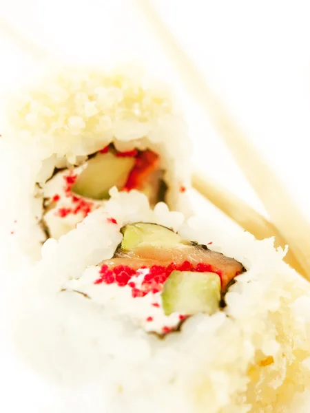 Two sushi roll with salmon and chopsticks over white — ストック写真