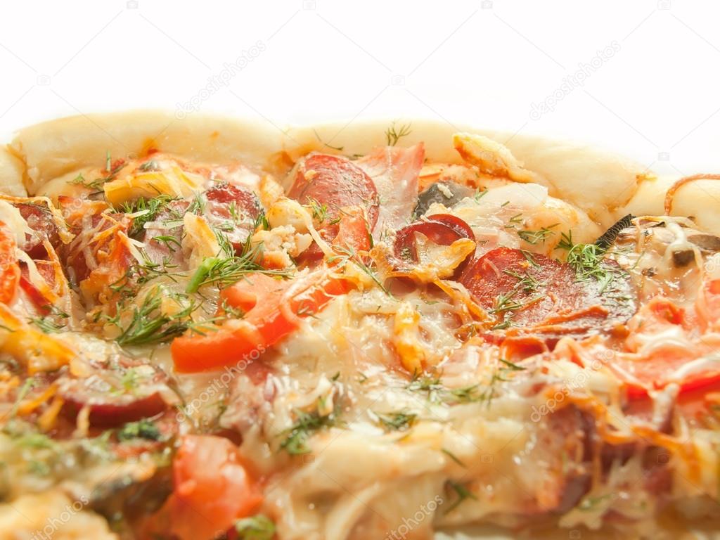 Pizza with tomato and salamy closeup isolated on white