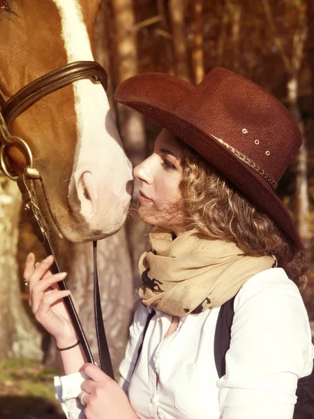 Porträt eines Cowgirls mit ihrem roten Pferd. — Stockfoto