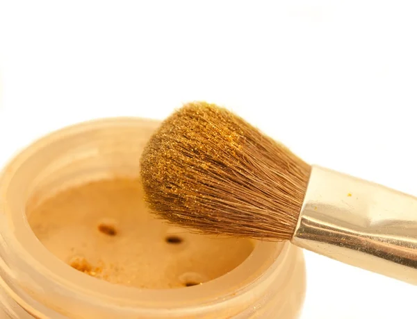 Gold make-up eyeshadows and cosmetic brush — Stock Photo, Image