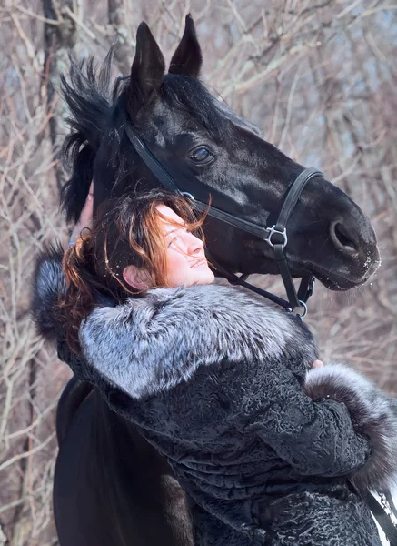Mulheres agradáveis com retrato de cavalo preto . — Fotografia de Stock