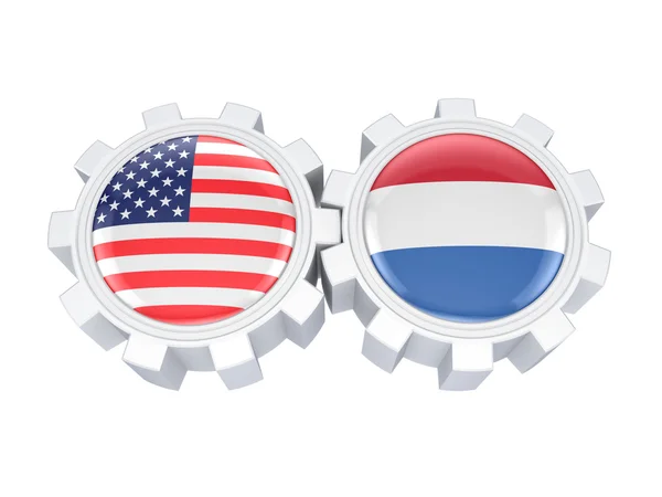 Drapeaux américains et néerlandais sur un engrenage . — Photo