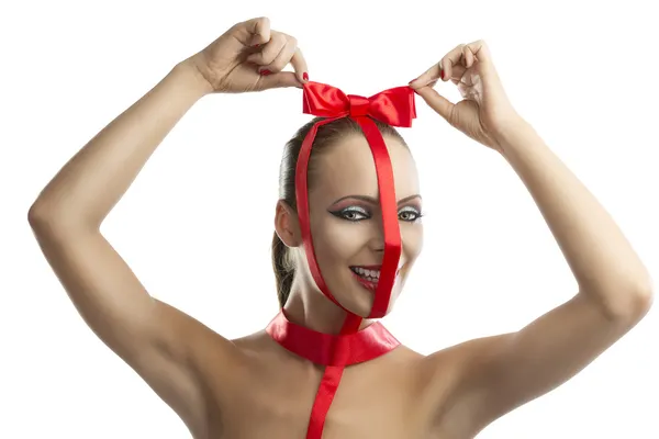 Beauty portrait of girl with red bow with hands on the head — Stock Photo, Image