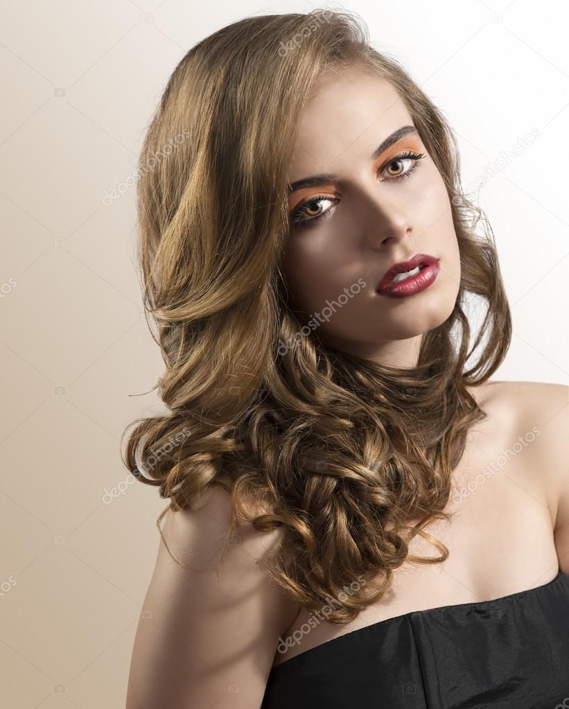 portrait of girl with wavy hair and folded head