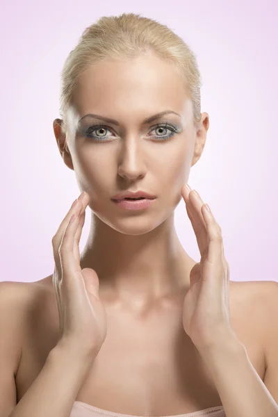 Beauty portrait of blonde girl with hands near the face — Stock Photo, Image