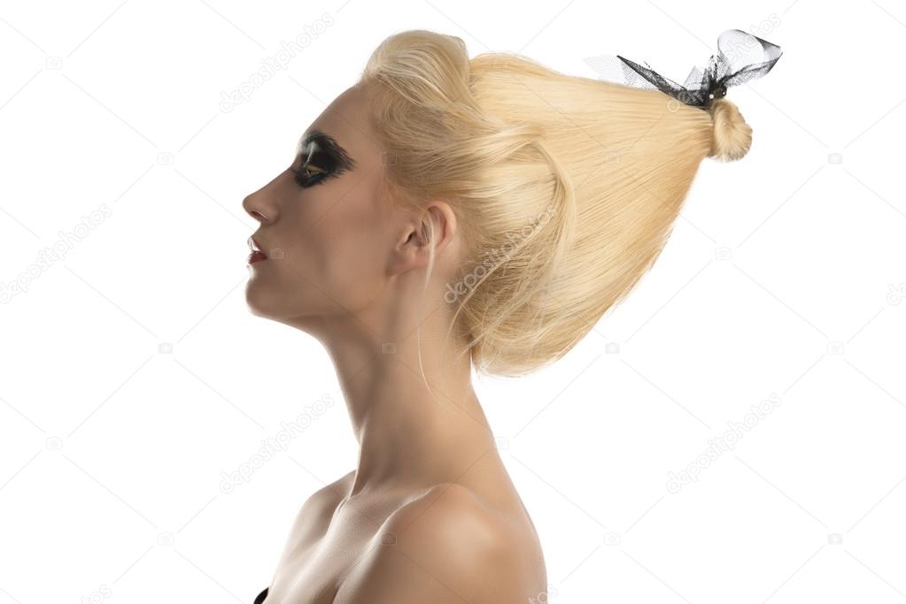 blonde girl with dark make-up in profile