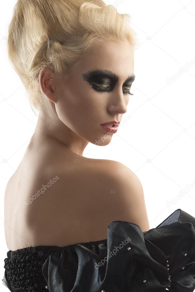 blonde girl with dark make-up looks down