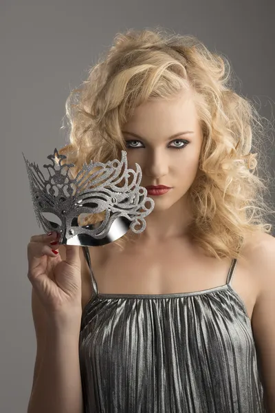 Blonde girl with silver mask in front of the camera — Stock Photo, Image