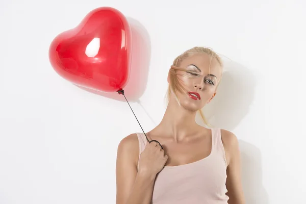 Sexy blonde girl with balloon and hand near the shoulder — Stock Photo, Image