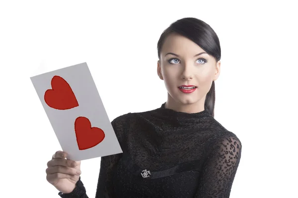 Pretty brunette with valentine postcard looks up — Stock Photo, Image