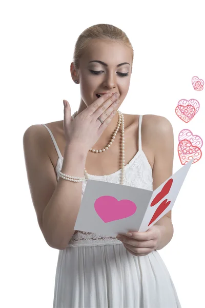 Surprised blonde girl reads valentine postcard — Stock Photo, Image