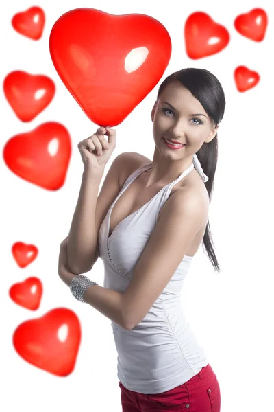 Sexy brunette takes the heart shaped balloon — Stock Photo, Image