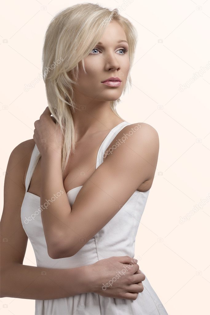 blonde girl with layered haircut and hand on the neck