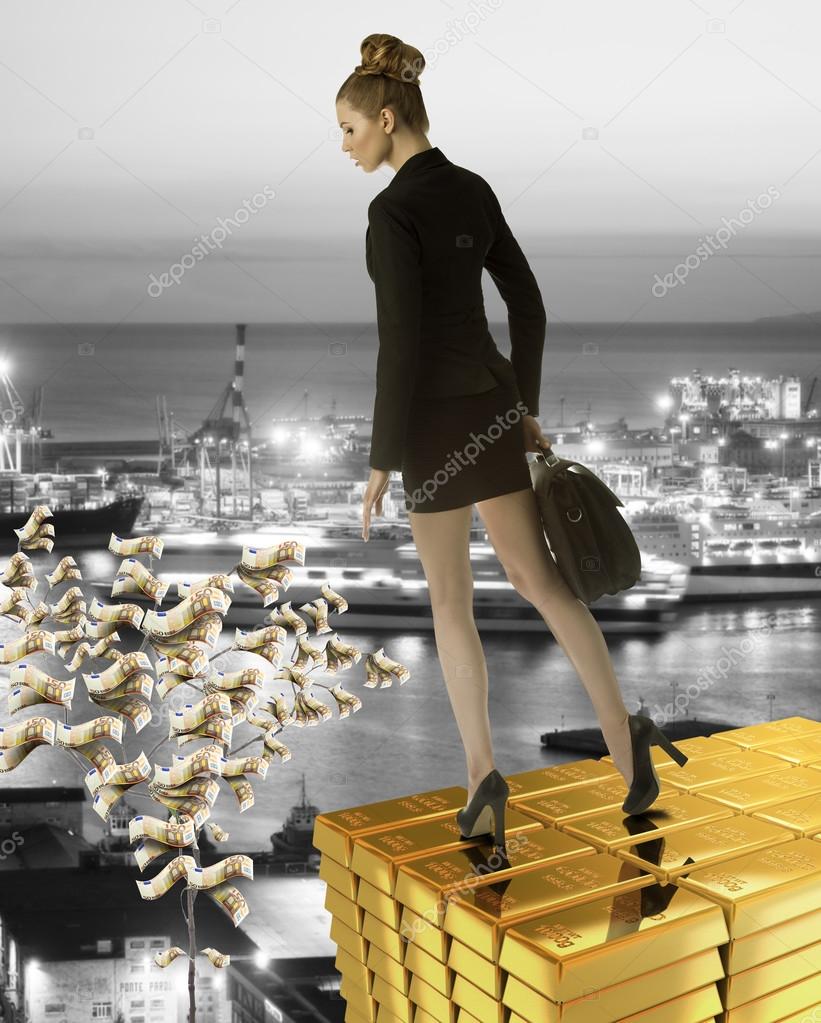 Nice business woman on gold tower near sea port