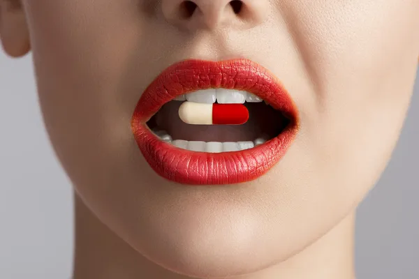 Bellezza labbra femminili con pillola — Foto Stock