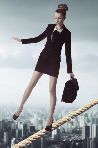 Business woman in unstable balance — Stock Photo, Image