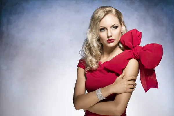 Blond young girl in red with big bow — Stock Photo, Image