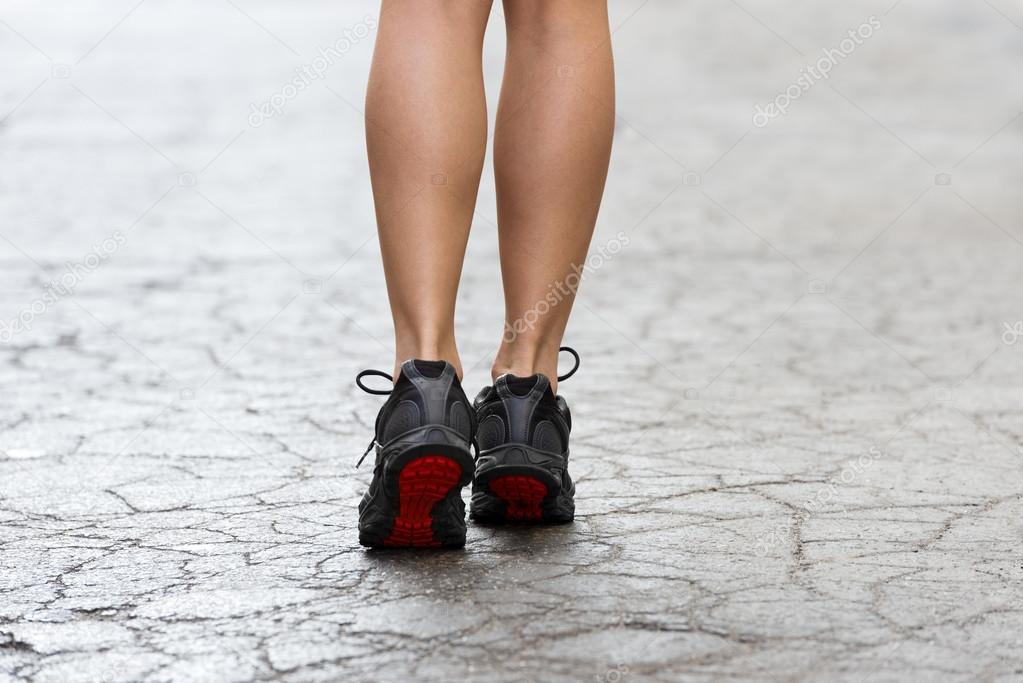 close up on gym shoes on crack street