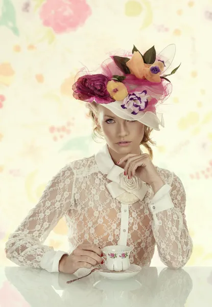 Elegant girl with cup of tea looks in to the lens Royalty Free Stock Images