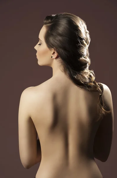 Woman with bare back and hairdo Royalty Free Stock Photos
