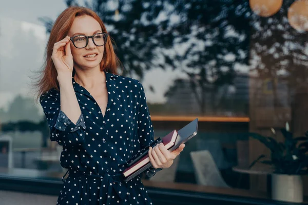 L'imprenditore femminile porta smartphone tablet e l'organizzatore posa vicino alla finestra del ristorante — Foto Stock