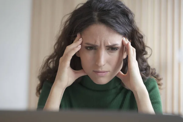 stock image Concerned young italian woman employee looking at computer screen with frustrated face expression