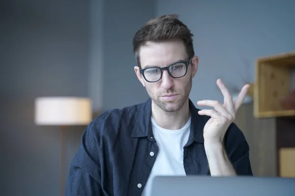 Young focused German man teacher tutor talking with students during online lesson on laptop — Stockfoto