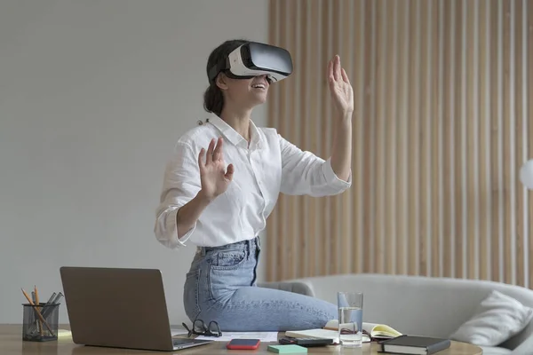 Imponująca kobieta biznesu siedzi na stole biurowym i używa okularów VR — Zdjęcie stockowe
