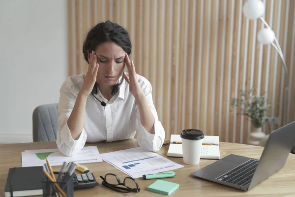 Frustrated upset italian woman holding head in hands suffering from headache after hard working day — Foto Stock