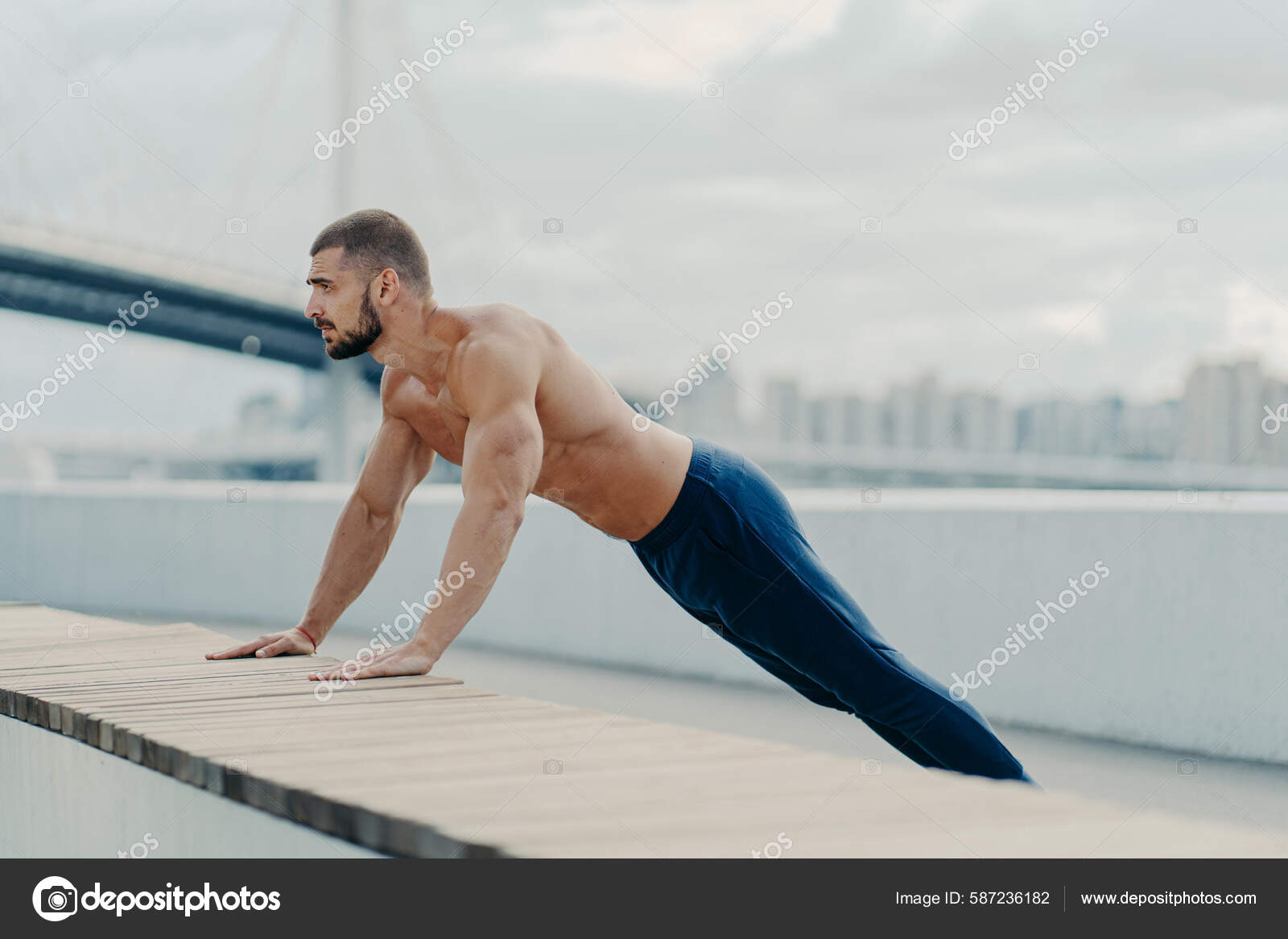 Naked Bodybuilder Posing While Doing Push-ups Stock Photo