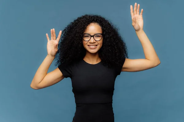 Glad Female Raises Hands Moves Happily Has Slim Body Shape — Stockfoto