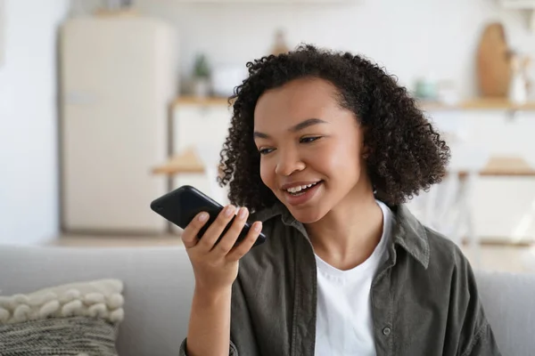Friendly African American Young Girl Sit Couch Home Hold Smartphone — Stockfoto