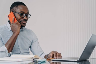 African american businessman has phone call in front of camera of computer. Happy guy in formal wear has video meeting in zoom. Remote conference or consultation at home. Online freelance job.