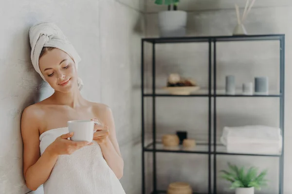 Satisfied Healthy European Woman Poses Wall Bathroom Wrapped White Soft — Stockfoto