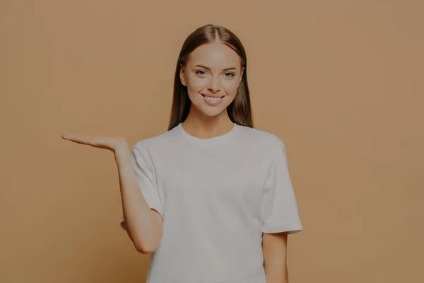 Joven Mujer Positiva Alegre Levanta Palma Sobre Espacio Copia Blanco — Foto de Stock