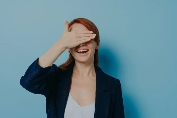 Playful Funny Ginger Girl Covering Her Eyes Palm Isolated Blue — Fotografia de Stock