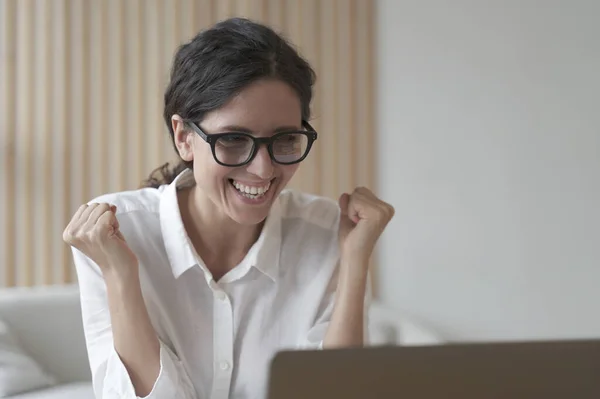 Excited Italian Woman Glasses Looking Laptop Screen Celebrating Work Success — стоковое фото