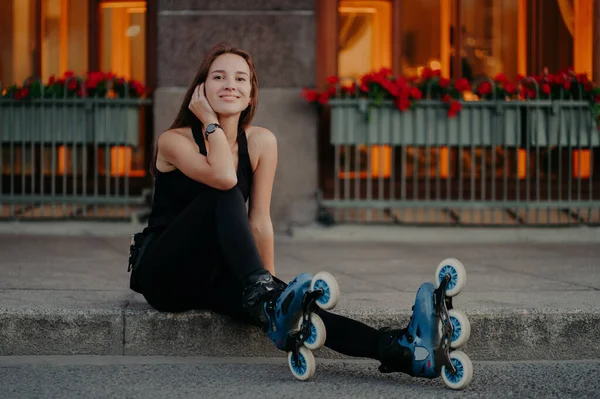 Horizontal Shot Active Young Woman Takes Break While Riding Rollers — Fotografia de Stock