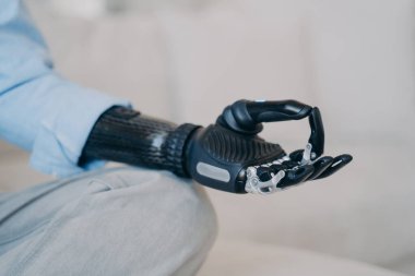 Biyonik protez kolu olan engelli biri sakinlik hareketi yapar, yoga yapar, sakinleşir. Sakatlığı olan, meditasyon yapan, zihnini rahatlatan, stresle başa çıkan sakin bir kadın. Yakın plan..