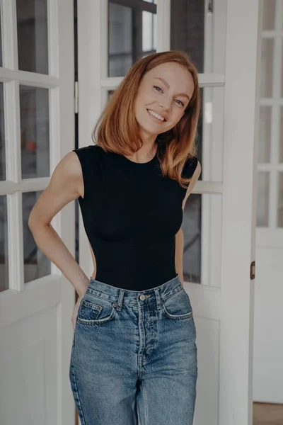 Lovely Redhead Caucasian Model Bodysuit Jeans Standing Door Window Smiling — Stock Photo, Image