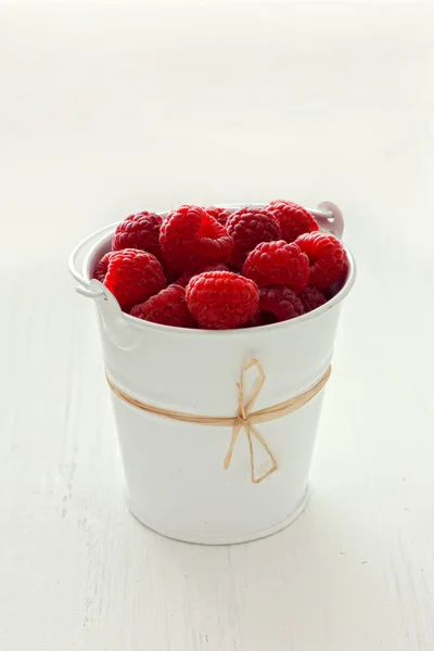 Raspberries in white bucket — Stock Photo, Image