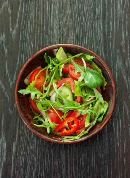 Vegetable salad over dark wood background — Stock Photo, Image